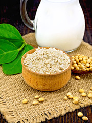 Flour soy in bowl with soybean and leaf on board