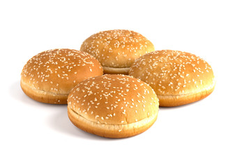 Burger buns on white background. A few buns cut in half close up on a white background.