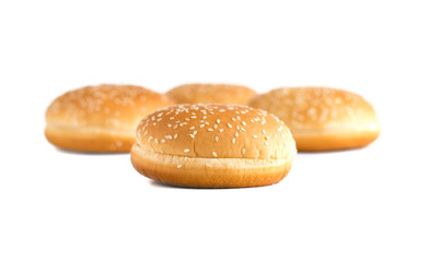 Burger buns on white background. A few buns cut in half close up on a white background.