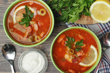 Two bowls with traditional Russian soup solyanka
