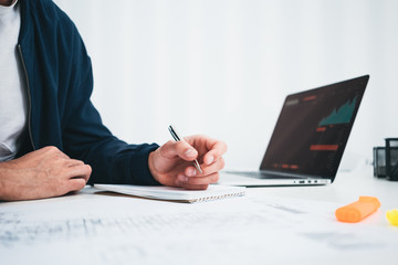 Architect disign concept blueprint. Young man designer sketching a construction project at notebook and drawing plan while working at office