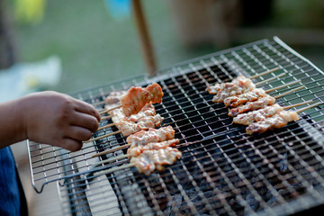Barbecue pork Toast grill or Toast pork with Thai garnish nutrition preparation for cooking. Thai food, Street food.Pork satay grilling on stove or Thai style roasted pork at the market.