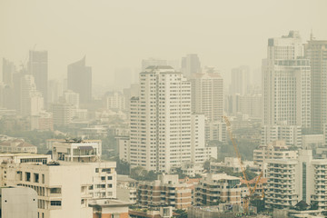 cityscape of high rise buildings in poor weather morning, haze of pollution covers city