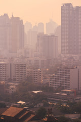 cityscape of high rise buildings in poor weather morning, haze of pollution covers city