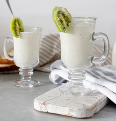 Fresh blended  kiwi protein smoothie with yogurt or milk in glass jar, healthy eating