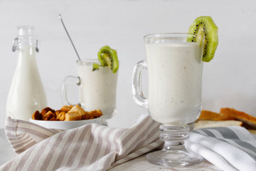 Fresh blended  kiwi protein smoothie with yogurt or milk in glass jar, healthy eating