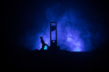 Horror view of Guillotine. Close-up of a guillotine on a dark foggy background.
