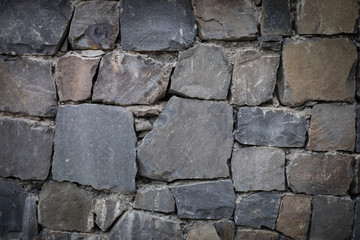 close up of a old and cracked stoned wall. Autumn time. Outdoor.
