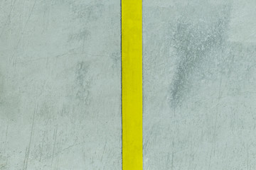 Fototapeta premium concrete wall. filmed in dark weather. it has a strip of yellow color. divided into two parts