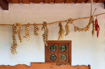 View of the terrace of an old Ukrainian rural hut with an antique window under a wooden roof