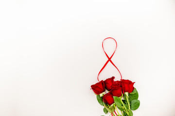 Bouquet of red  roses with a red ribbon. Eights march woman's day, holiday. Flowers on a white background copespace. Horizontal top view, number 8 in a ribbon