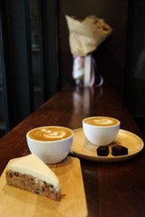 Two cup of latte coffee for lover with tulip pattern art on top with carrot cake and brownie chip with copy space