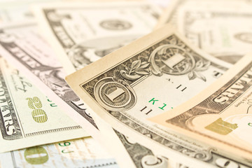 Abstract background of various dollar bills. Selective focus.