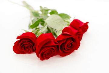 Bouquet of red  roses with a red ribbon. Eights march woman's day, holiday. Flowers on a white background copespace. Horizontal top view