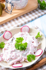 delicious homemade meat salad with mayonnaise and cucumber