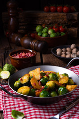 Brussels sprouts potato pan with bacon in rustic style