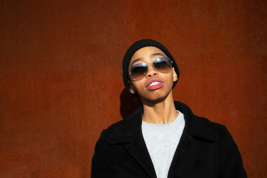 20s Teenager Cool Black African Woman With Sunglasses In Summer With Red Rustic Metal Background