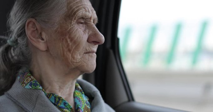 Close-up face of an old woman with wrinkles.