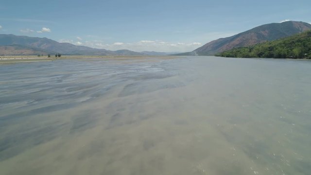 Parched river in mountain province Luzon, Philippines. Aerial view Drought in mountain valley, dry and shallow Bucao river.