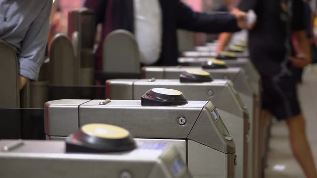 Many Ticket Gates With Commuters Scanning Cards and Entering Tube Station in London, UK