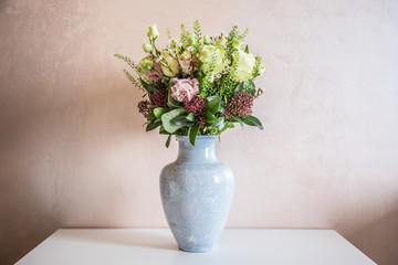Fototapeta na wymiar Bunch of elegant flowers in vase as love or Valentines day attribute image