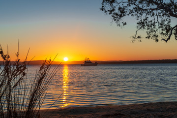 Fototapeta na wymiar Sunset over calm water. Myall Lakes, Australia