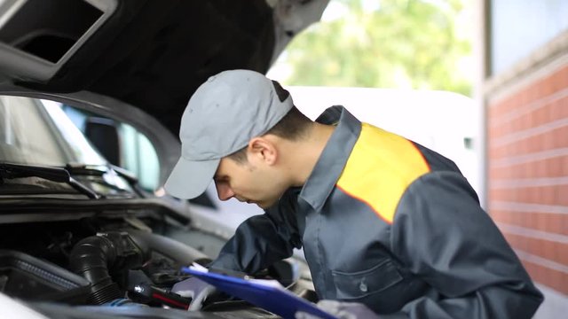 Mechainc fixing a van engine