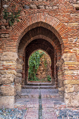 Arabian arch in Nasrid Palace. Arcade with Arabian ornaments in Alcazaba de Malaga, Andalucia, Spain