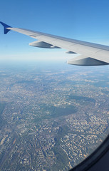The wing of the plane and the city