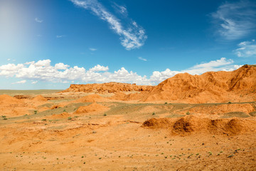 Plakat View onto the Flaming Cliffs (Bajandsag) in the heart of Gobi Desert on a perfect blue summer day (Gobi Desert, Mongolia, Asia)