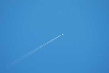 Airplane flying in the blue sky.