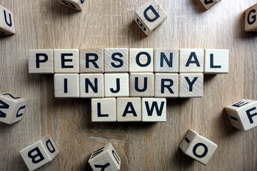 Personal injury law text from wooden blocks on desk