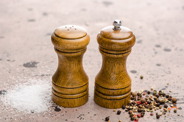 Wooden salt shaker and pepperbox on a light background.