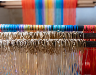 Colored threads of an ancient wooden loom