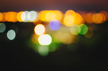 Abstract scattered background with bokeh. Glowing yellow spots on a dark background.