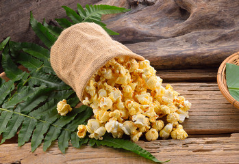 Yellow popcorn on wooden background