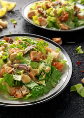 Caesar salad with chicken, anchous fish, croutons, parmesan cheese and greens. healthy food