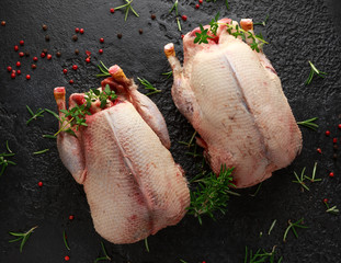 Raw wild mallard ducks with herbs. ready to be cooked. Game or quarry birds