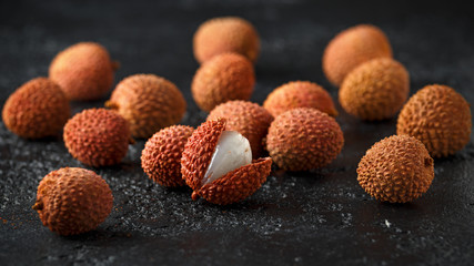 Tropical Lychee fruits, soapberry on rustic black table, background