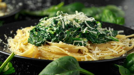 Tagliatelle pasta with spinach in cream sauce with parmesan