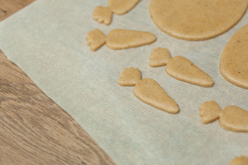 close up of female hands making cookies from fresh dough at home
