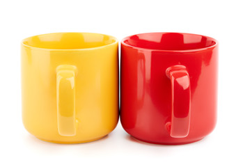 Colored cups for coffee and tea on a white background. Place for your text.