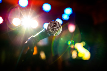 Microphone on stage against a background of auditorium.