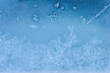 Ice flowers and crystals on the window