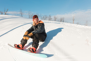 Fototapeta na wymiar happy sportsman is resting on the snow. relaxation. feeling, emotion . copy space