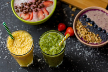 two glasses of delicious cocktail and yogurt on the black table. blurre background. breakfast