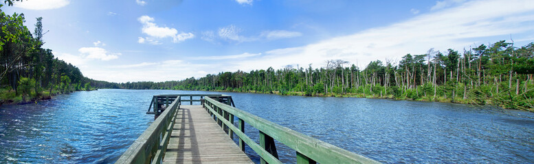Wooden pier on the shore of the lake.