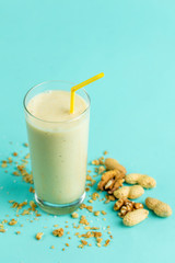a glass of vanilla milkshake isolated on blue background. isolated blue background. diet concept