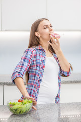 pregnant woman eating donut refusing vegetables