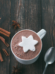 Hot chocolate with marsmallow in star or snowflake shape. Christmas and winter holiday concept. Copy space. Top view or flat-lay.